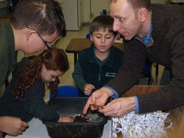 A King County Green Team specialist shows Green River students their new worm bin