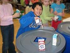 Issaquah School District: Elementary school children carefully empty leftover milk before recycling their milk cartons.