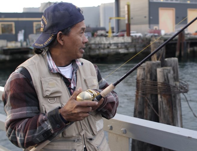 A fisherman on a dock. Photo by: Alex Montalvo of Revel Riter Media
