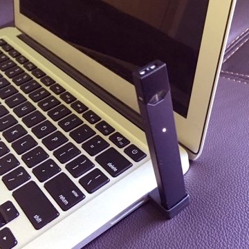 JUUL e-cigarette plugged into a laptop USB port