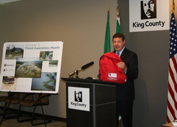 Councilmember Dunn demonstrates what an emergency preparedness kit can look like